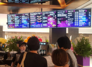 people looking at a menu board