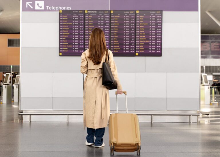 woman standing in front of departure screen