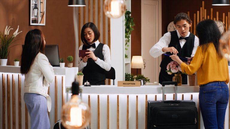 women checking in hotel at reception
