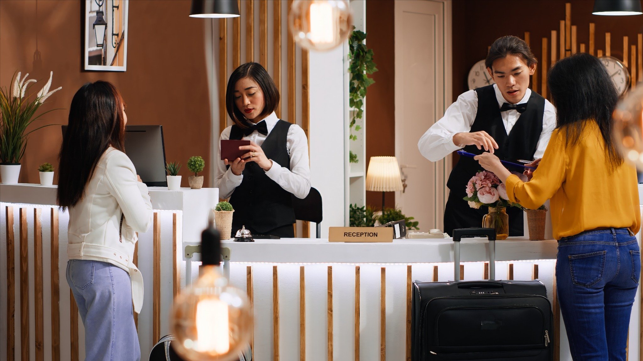 women checking in hotel at reception