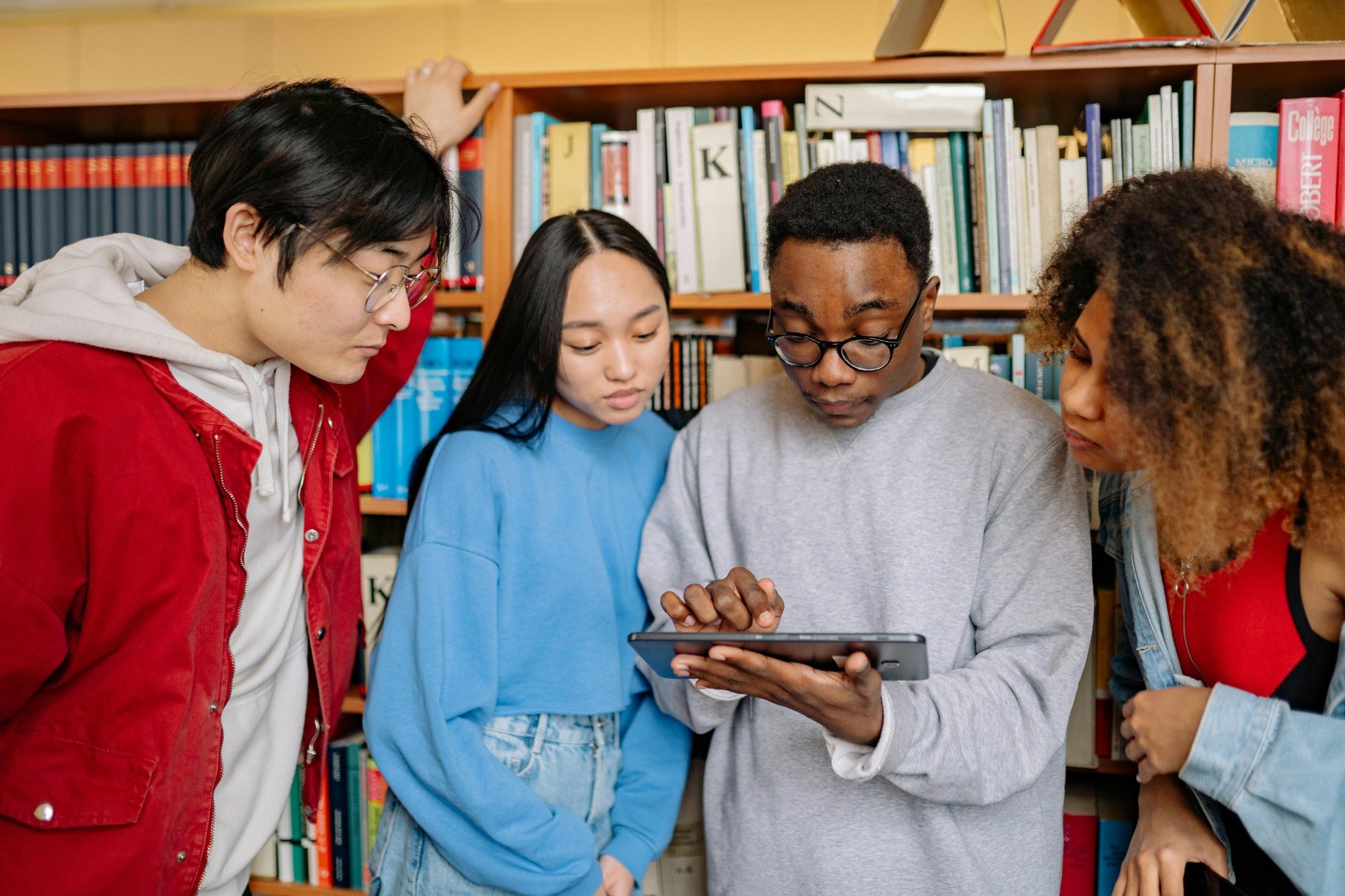 students using tablet in library